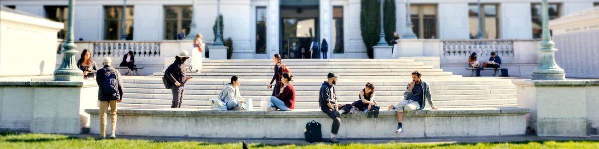 Students hanging out in front of Doe Library on a sunny day